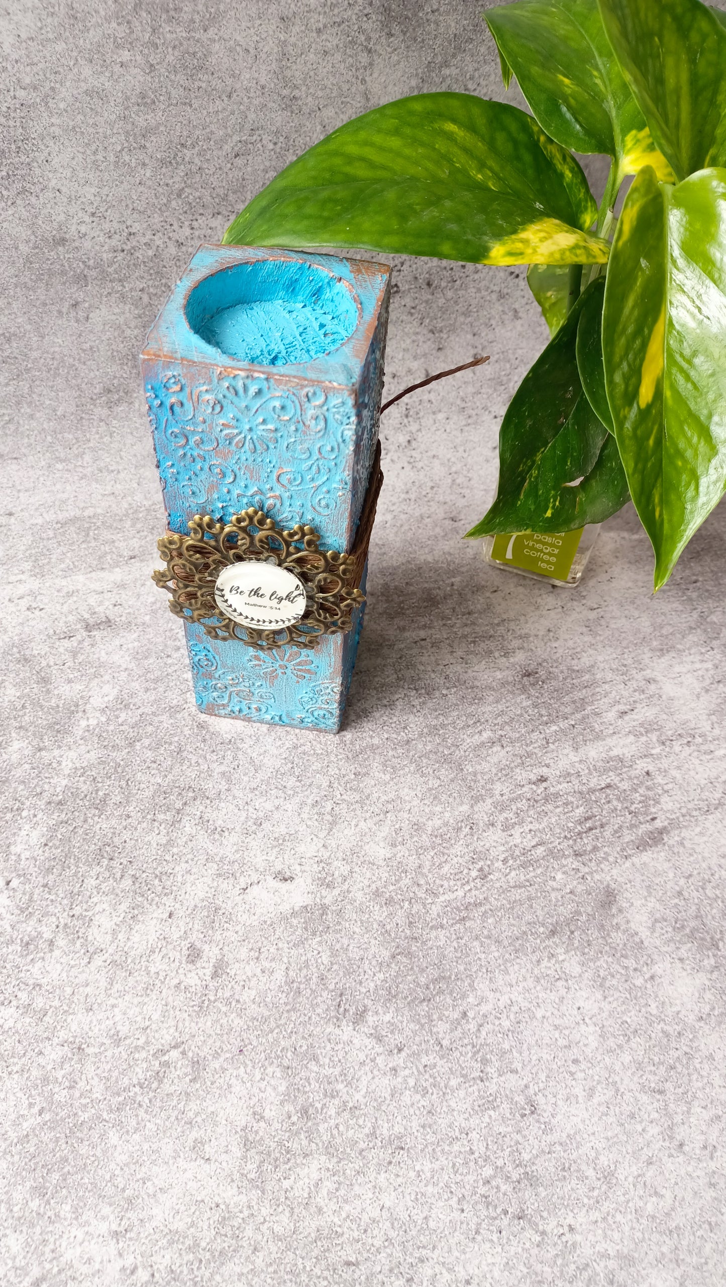 Top view of blue candle stand with 'Be the light' detail
