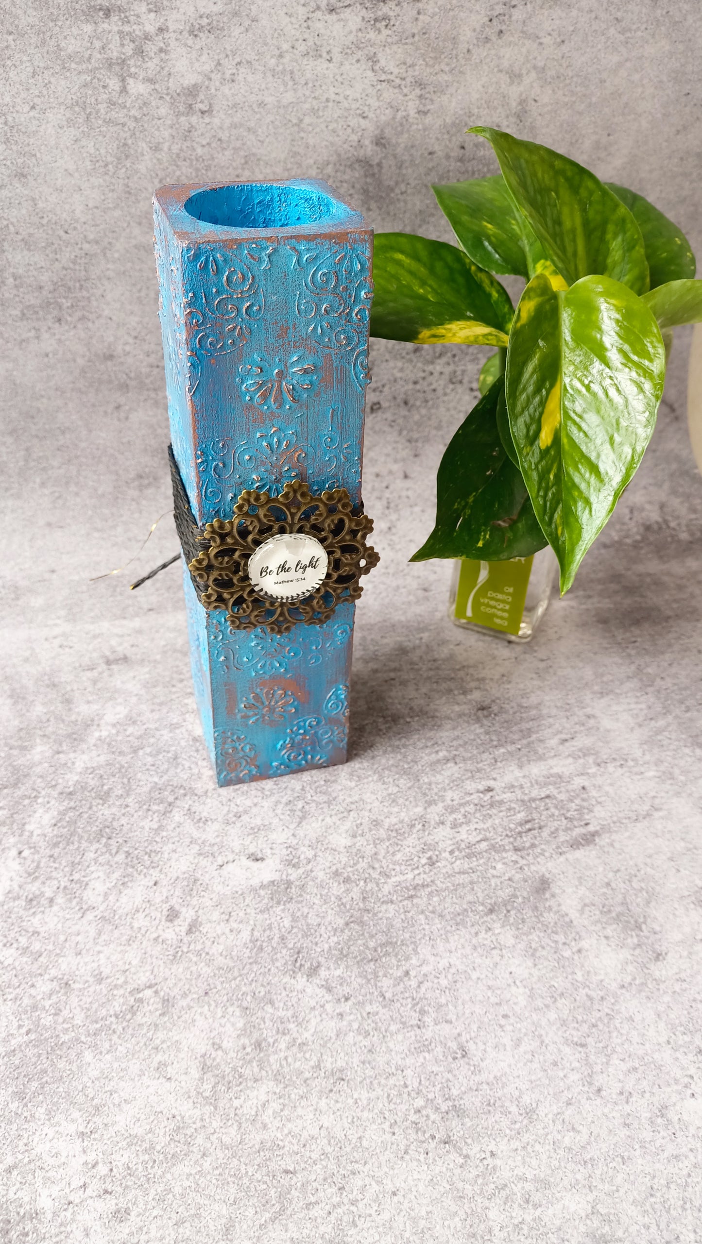 Vertical blue candle stand with 'Be the light' embellishment