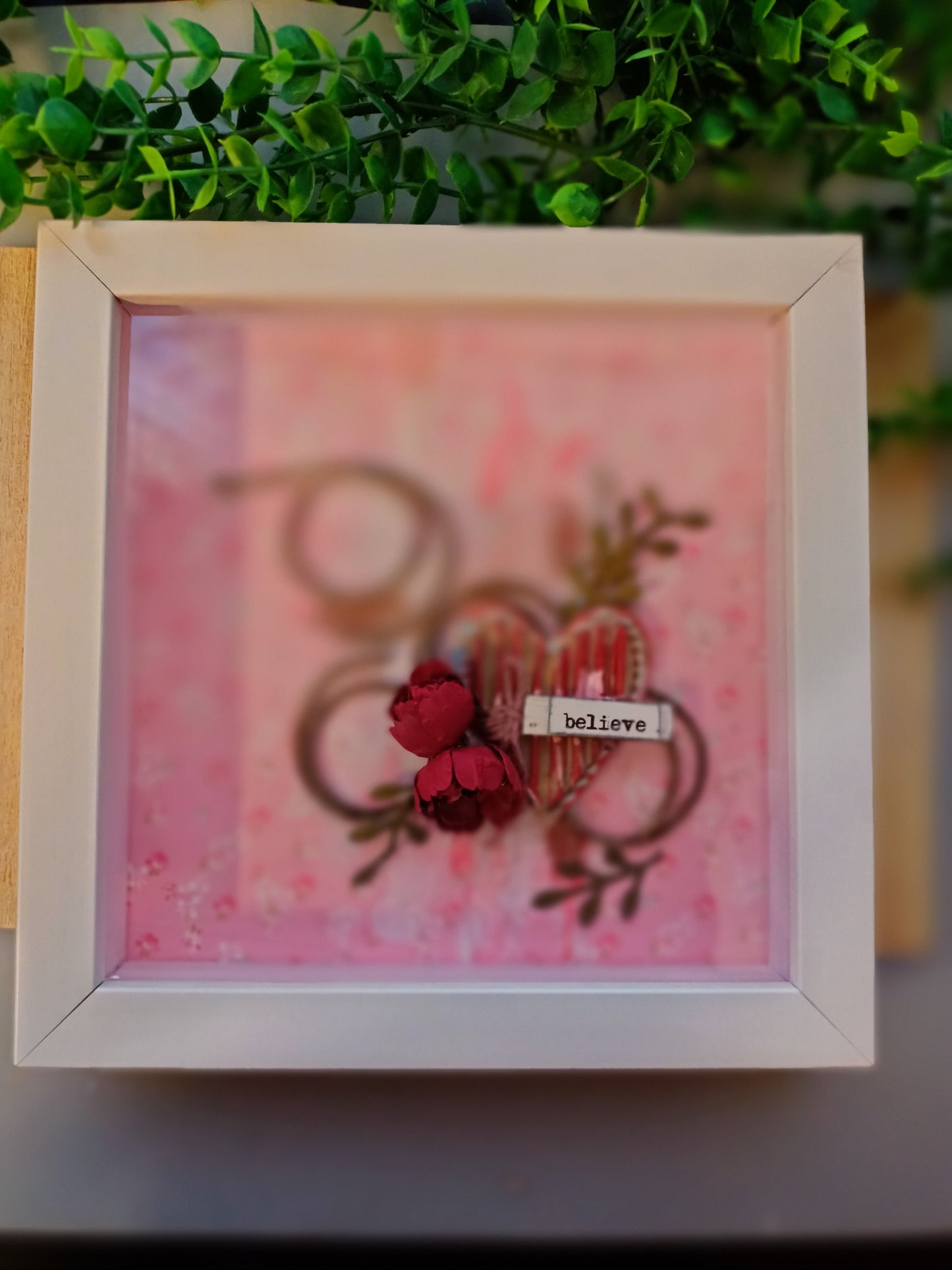 Inspirational frame with 'believe' inscription on pink background