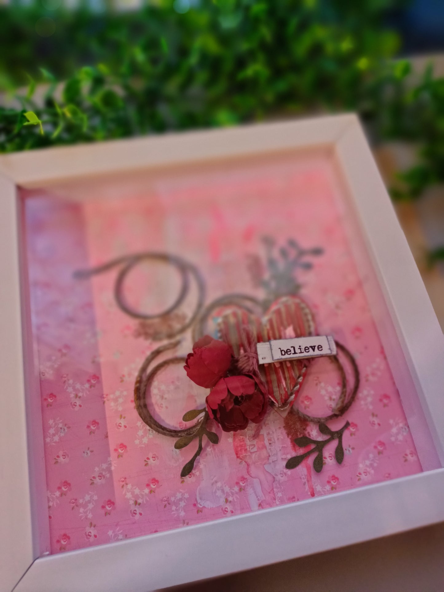 Decorative frame featuring 'believe' text and floral design