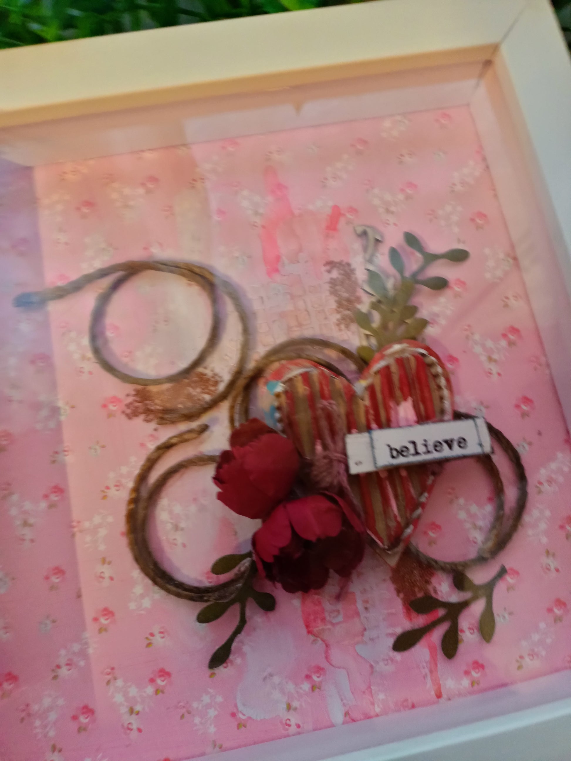 Pink themed frame with 'believe' inscription and floral accents