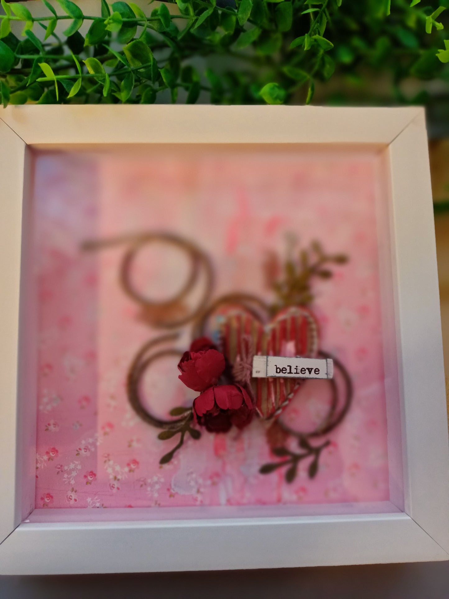 Inspirational frame with 'believe' text on floral background