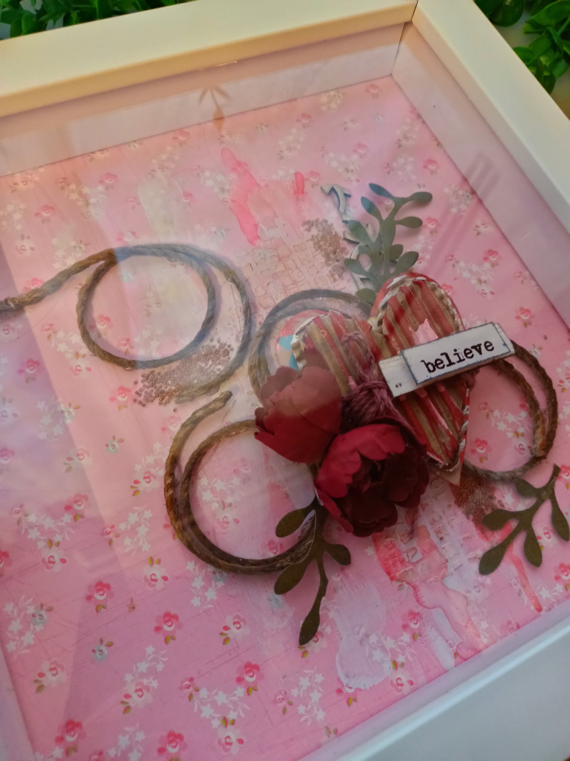 Decorative frame with 'believe' message and heart design