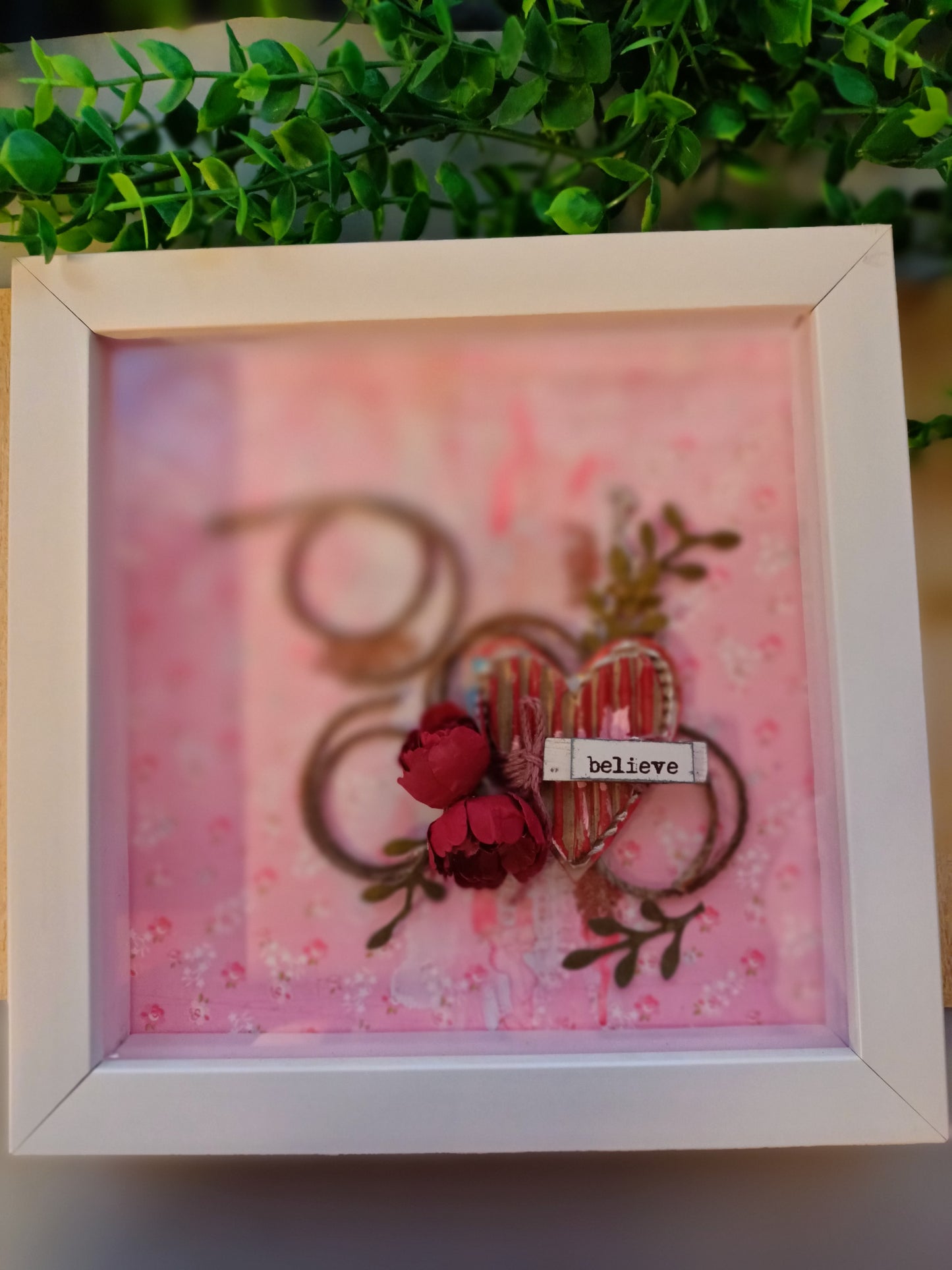 Inspirational frame with 'believe' text and heart motif