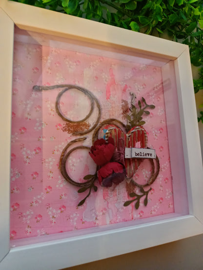 Decorative frame featuring 'believe' text and floral design