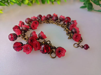 Efflorescence bracelet showcasing red floral charm design