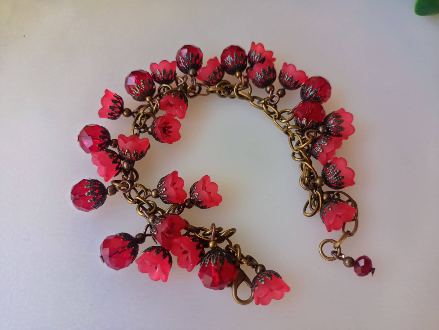 Efflorescence bracelet with vibrant red floral beads