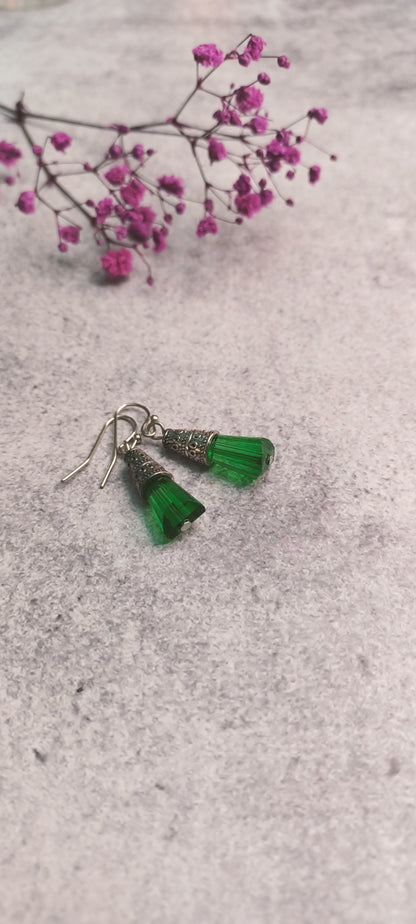 Green glass bead earrings with detailed metalwork