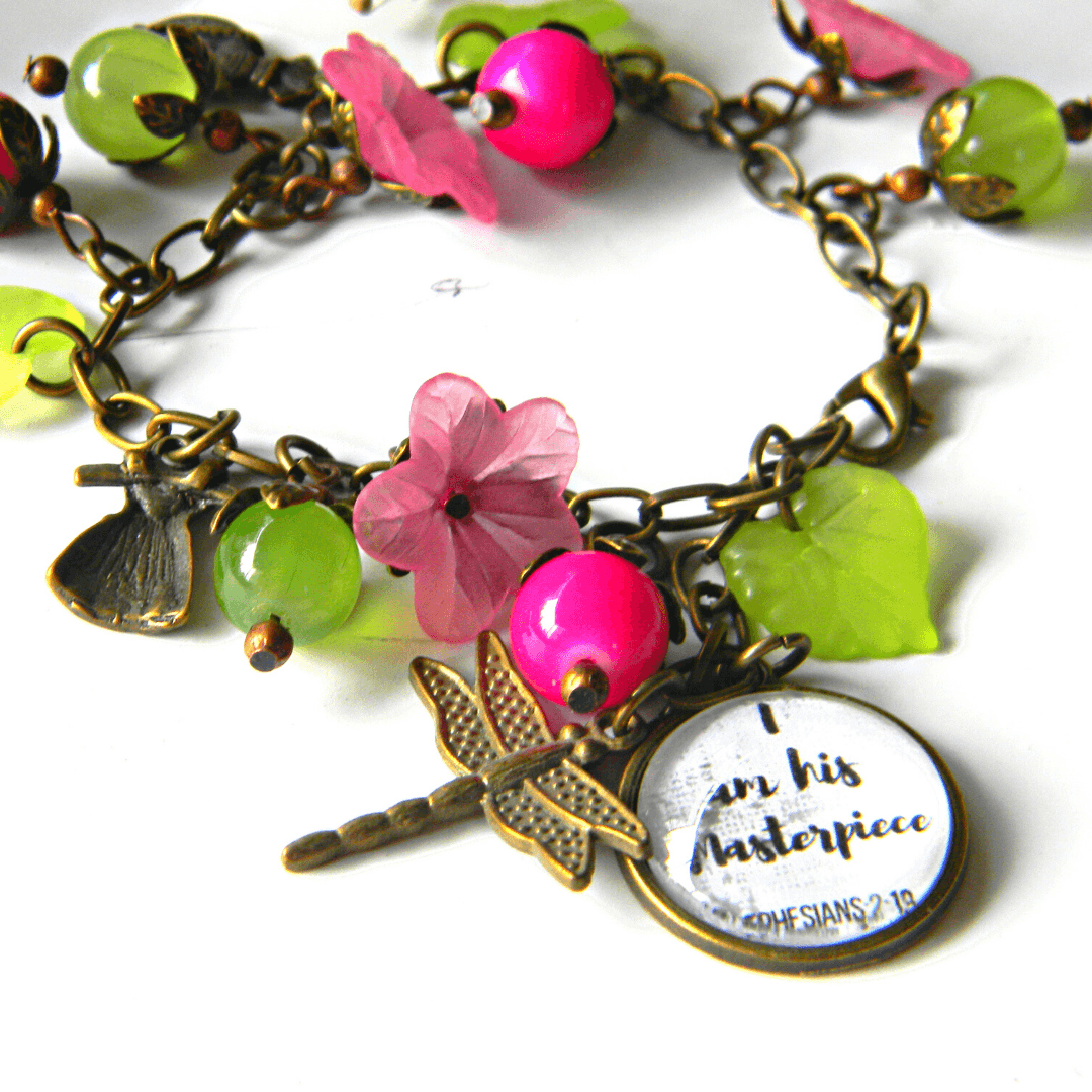 Vintage scripture bracelet with floral and leaf charms.