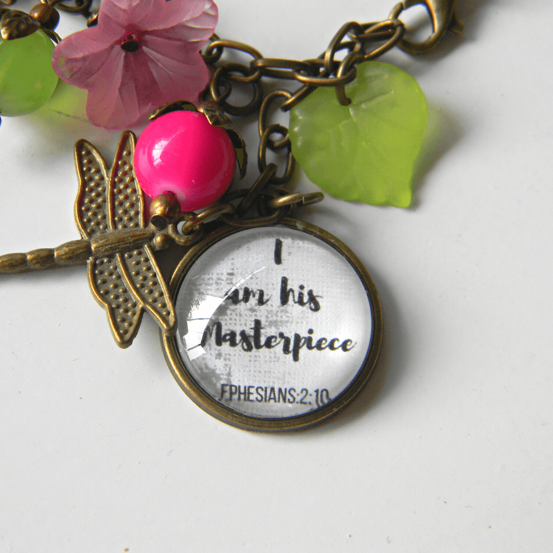 Close-up of scripture bracelet with 'I am his Masterpiece' charm.