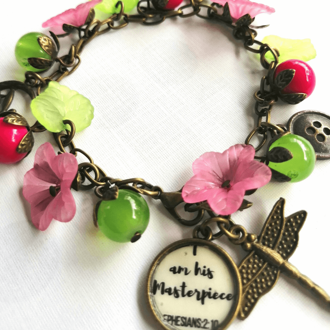 Scripture bracelet with pink and green beads, dragonfly charm.