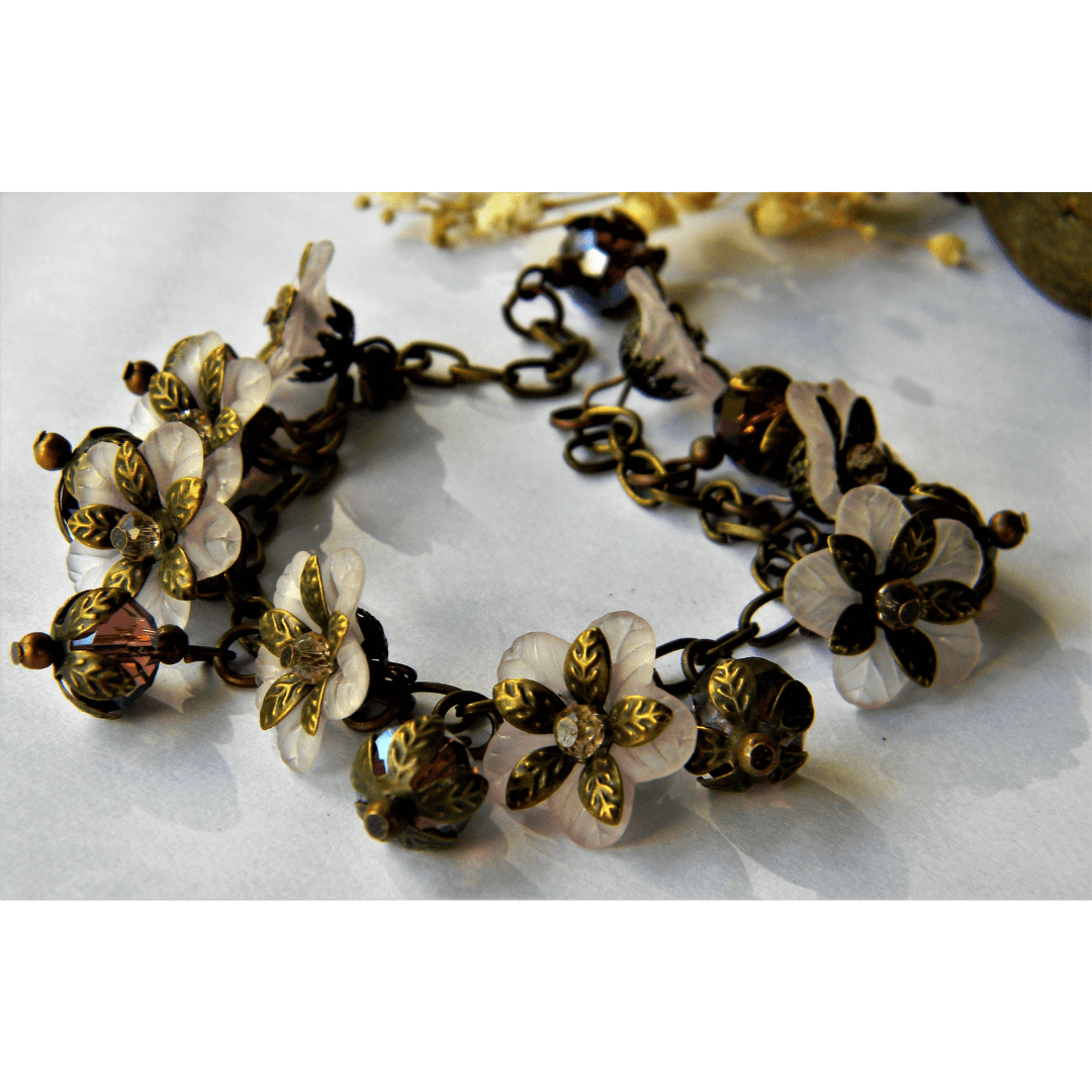 Handmade white bracelet with floral and vintage elements.