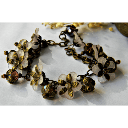 Handmade white bracelet with floral and vintage elements.