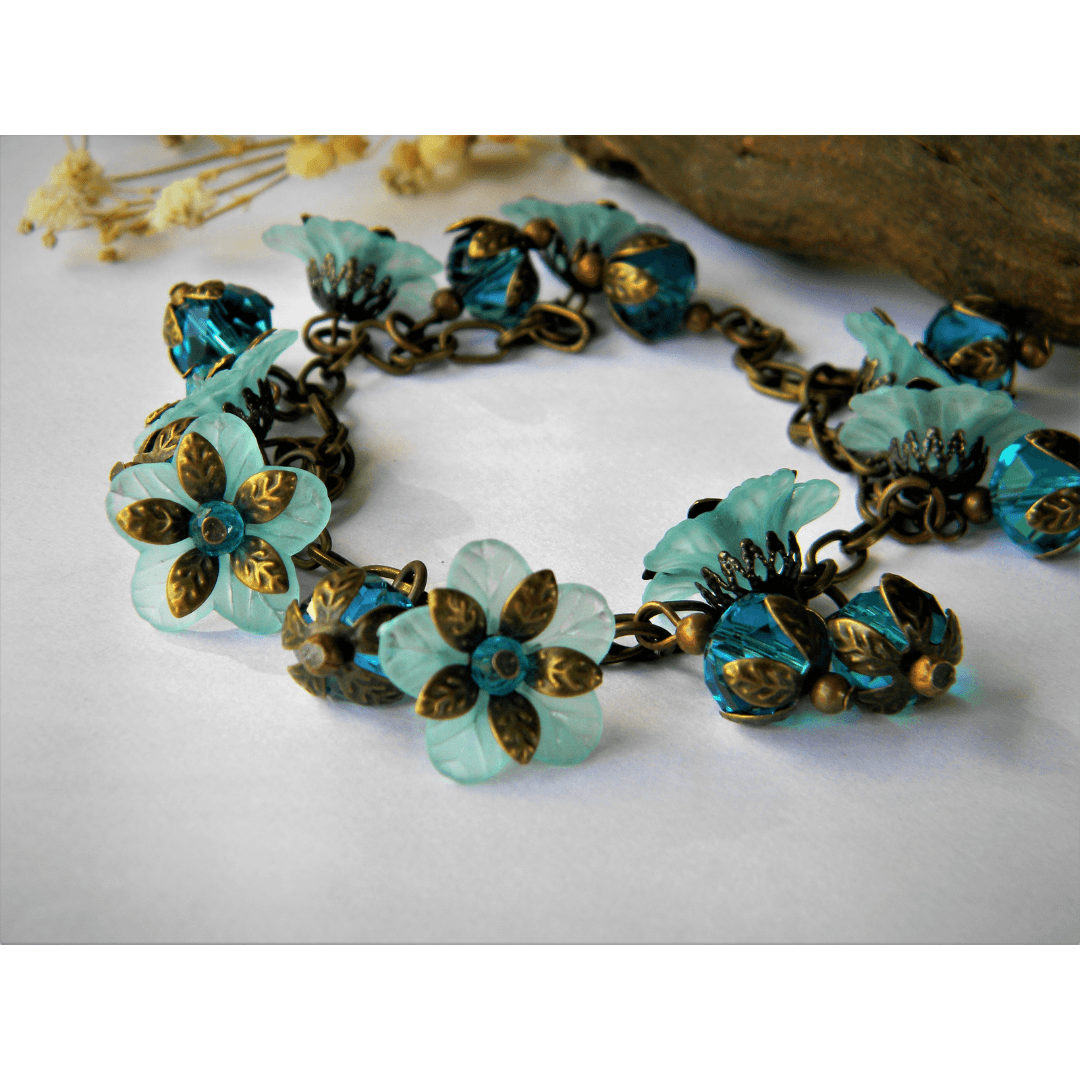 Aqua floral bracelet with glass beads and vintage charm.