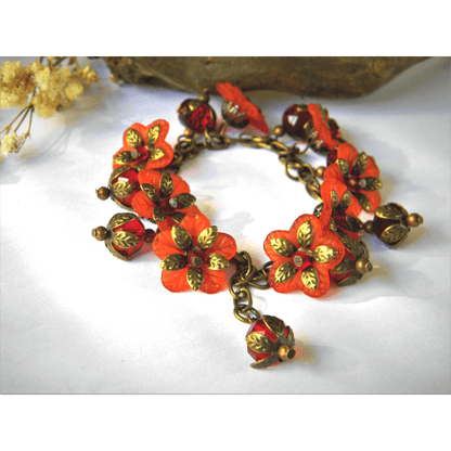 Handmade floral bracelet with red glass beads and vintage style.