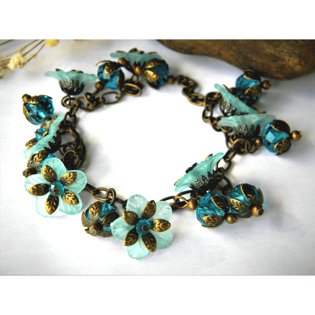 Handcrafted aqua bracelet with floral design and vintage style.