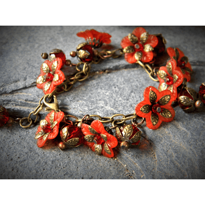 Red floral bracelet with intricate vintage-inspired design.