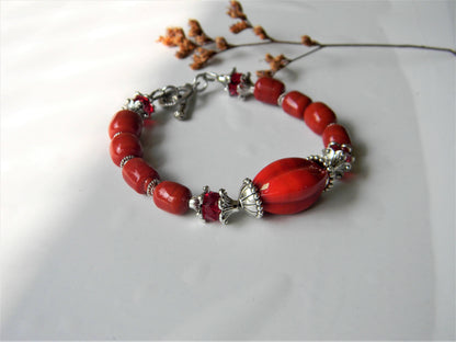 Red glass bead bracelet with intricate silver details